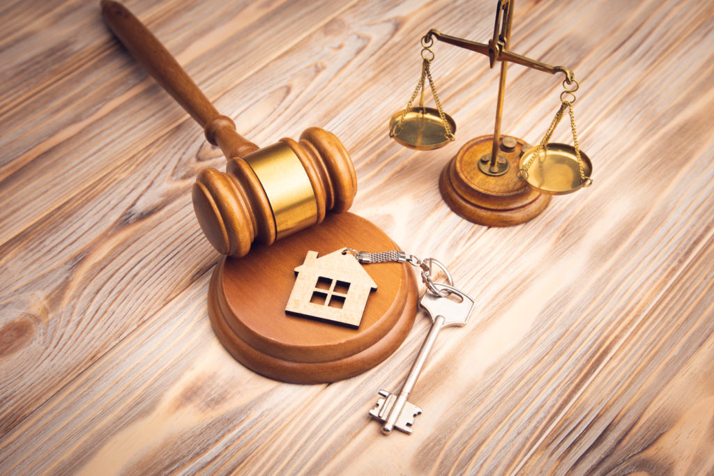 Judge,Gavel,And,House,Key,On,Wooden,Background.,Estate,Law