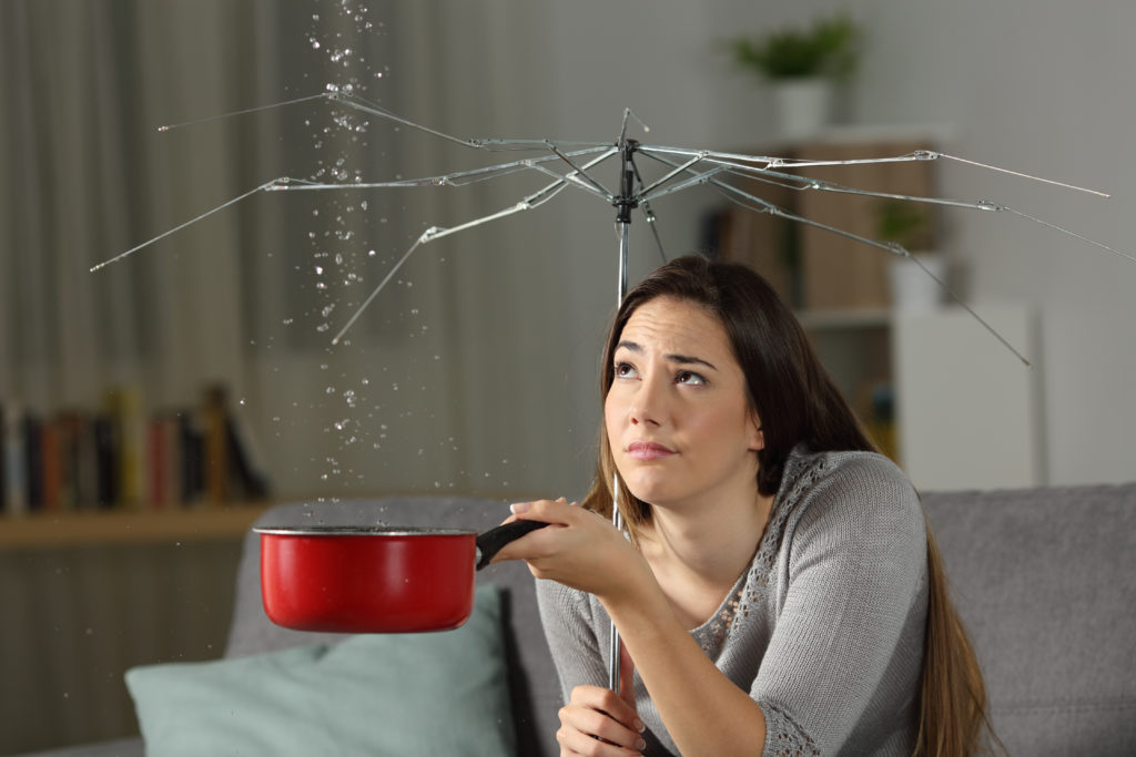 Woman,Suffering,Water,Leaks,At,Home,With,A,Broken,Umbrella.