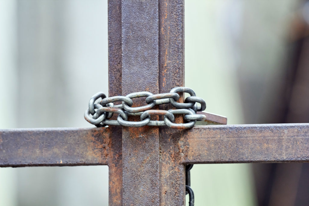 Chained,And,Locked,Rustic,Metal,Gate.