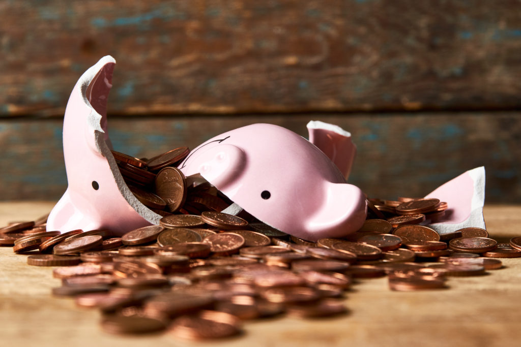 Broken,Piggy,Bank,With,Money,On,Wooden,Background,With,Copy