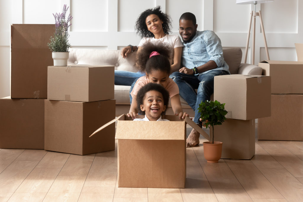 Happy,Small,African,American,Kids,Play,Riding,In,Cardboard,Boxes