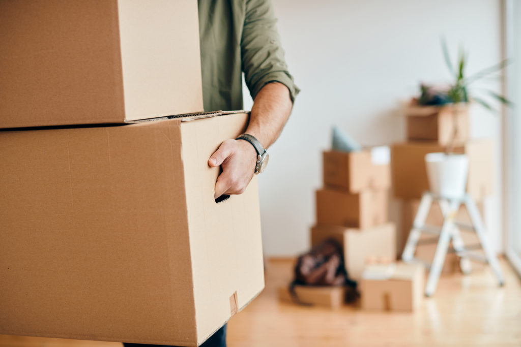 Close-up,Of,A,Man,With,Carton,Boxes,Moving,Into,New