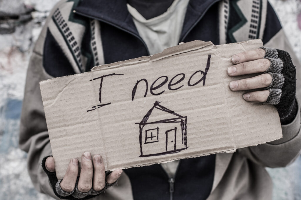 Young,Homeless,Man,Holding,Sign,"i,Need,Home"