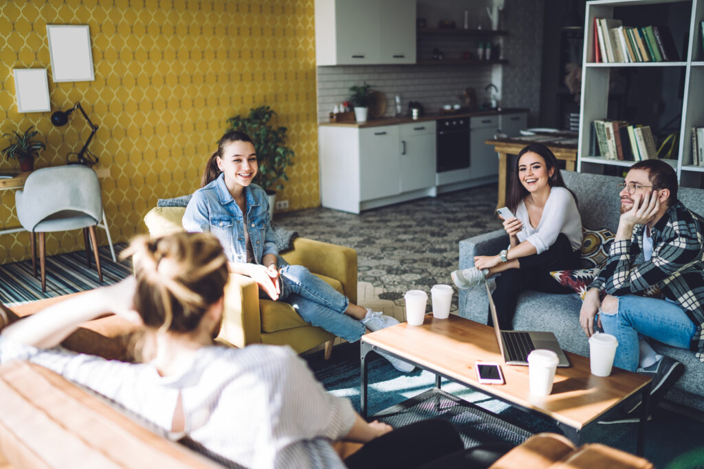 Group,Of,Young,Cheerful,Students,Sitting,In,Cozy,Small,Colorful