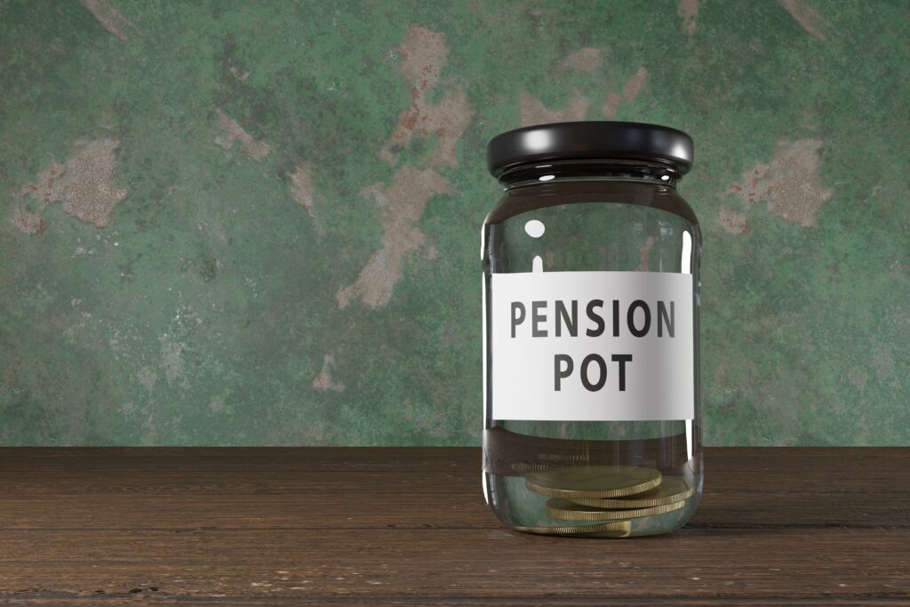 Glass,Jar,Labelled,As,Pension,Pot,On,A,Wooden,Table.