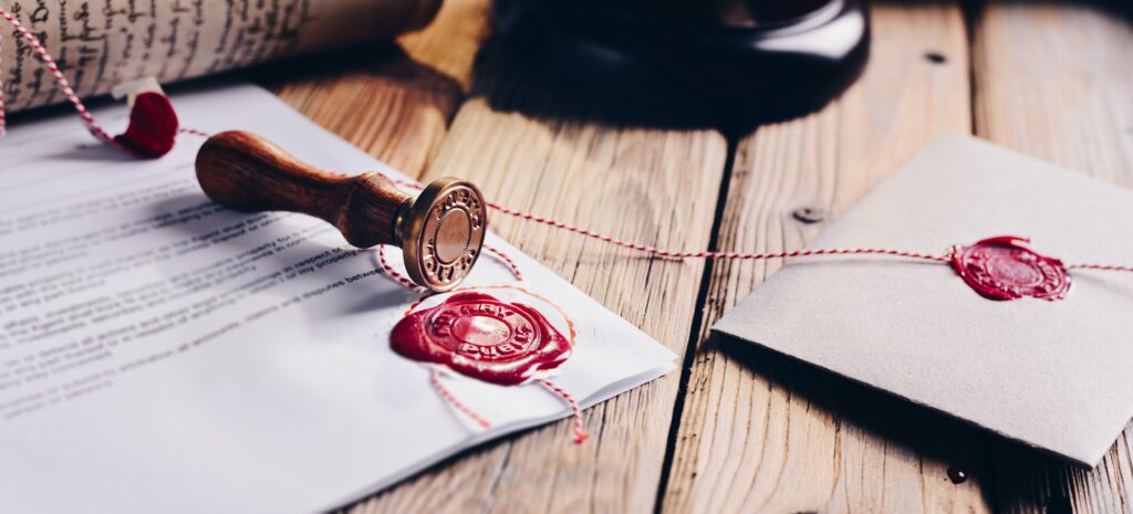 Notary,Public,Wax,Stamper,And,Wax,Seal,On,Document