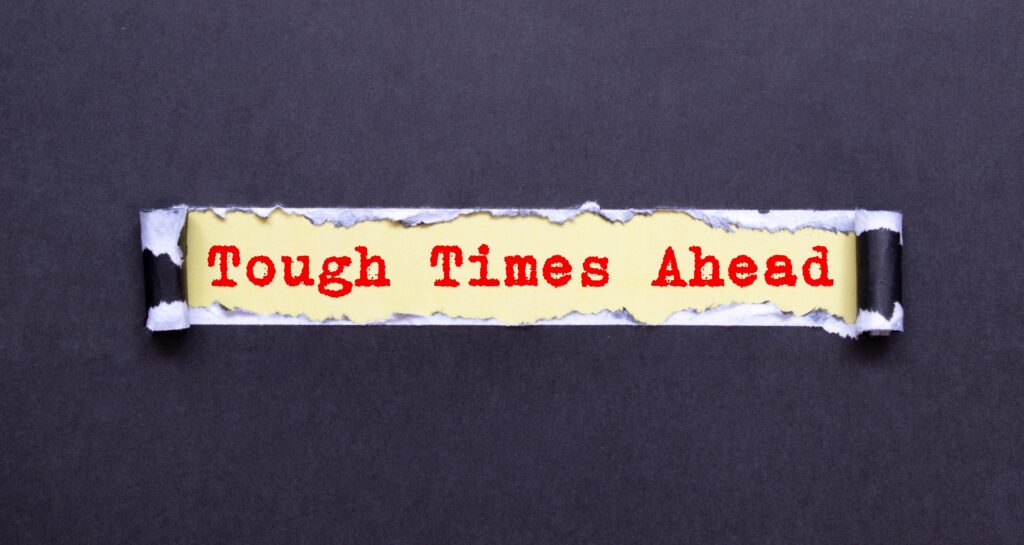 Text,Tough,Times,Ahead,On,Black,Torn,Paper