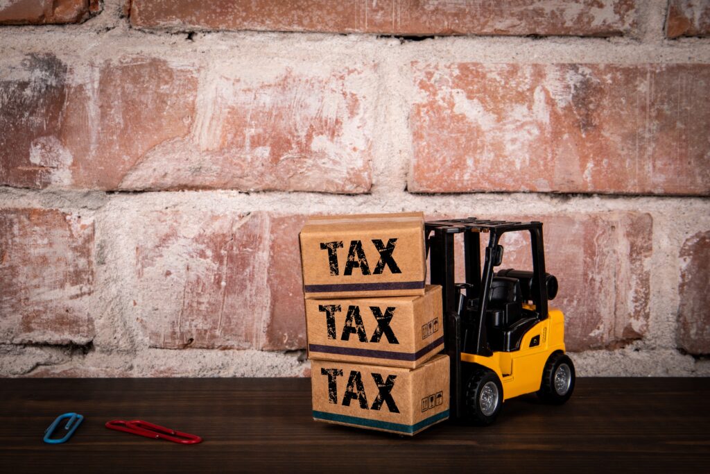 Tax,Concept.,Miniature,Cardboard,Boxes,And,A,Forklift,On,A