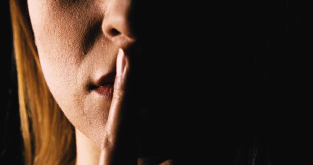 Seriouse,Woman,Placing,Her,Finger,On,Lips,-,Keep,Silence