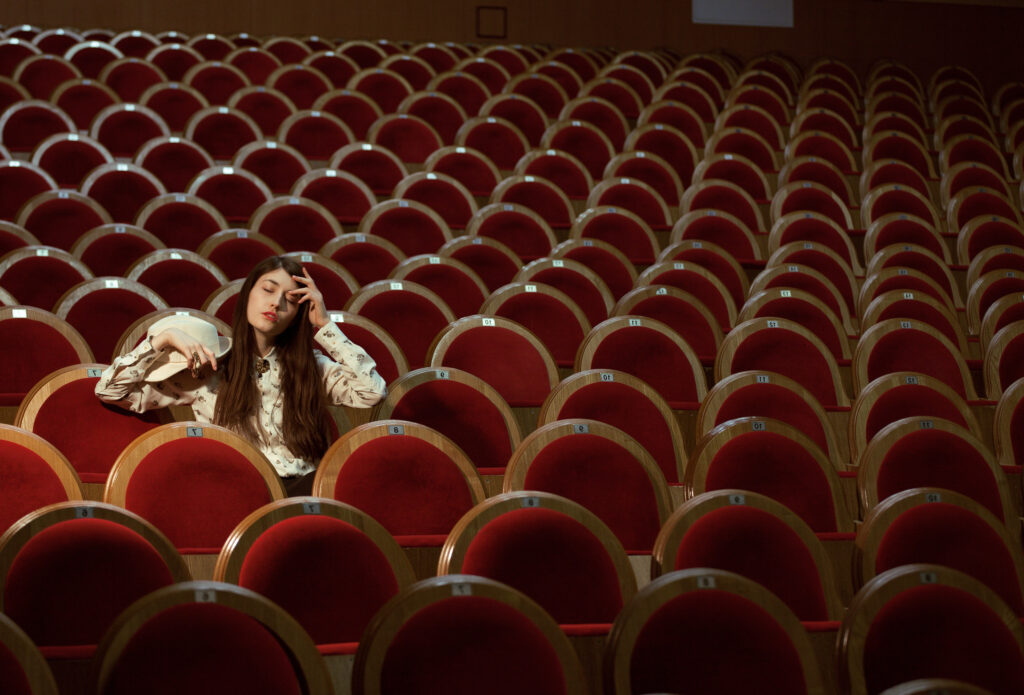 Portrait,Of,A,Pretty,Girl,In,A,Movie,Theater,Wearing