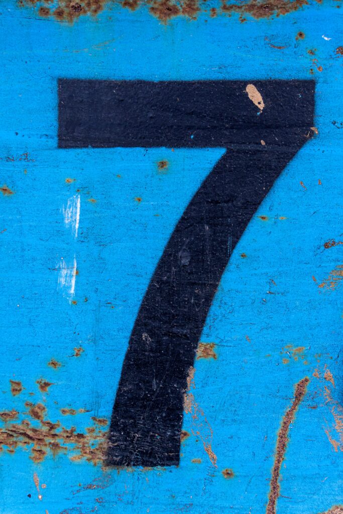 Number,7,In,Black,Paint,On,An,Old,Blue,Iron