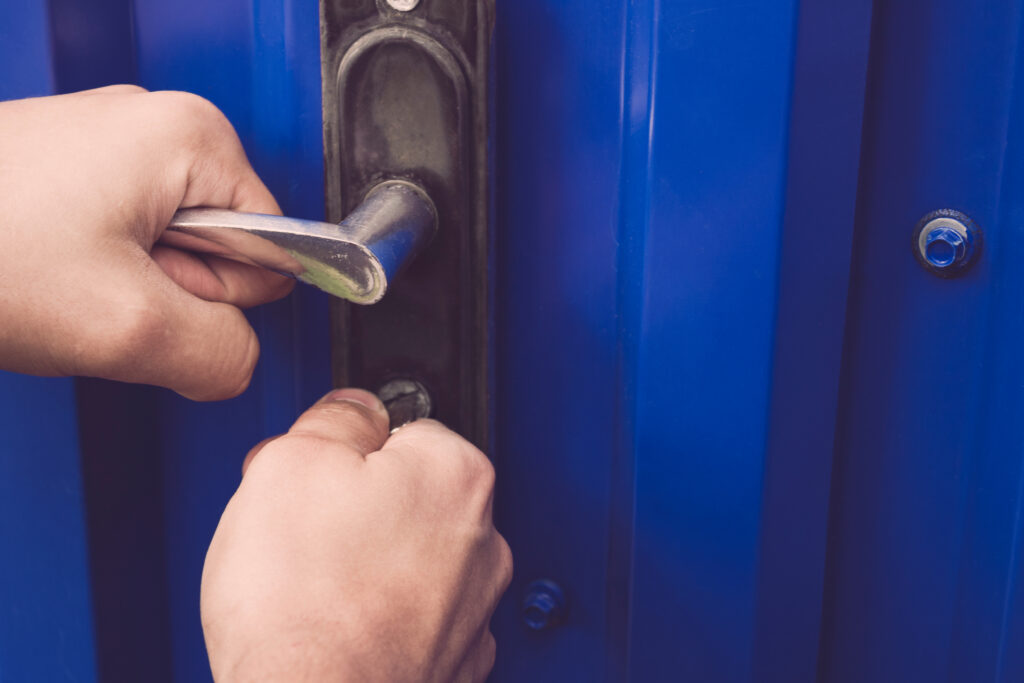 The,Man,Holds,The,Door,Handle,And,Opens,The,Gate