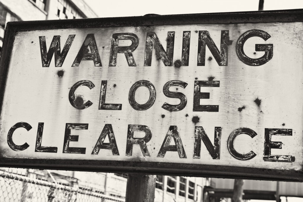 Sign,At,An,Abandoned,Automotive,Factory,-,Rusted,Sign,At